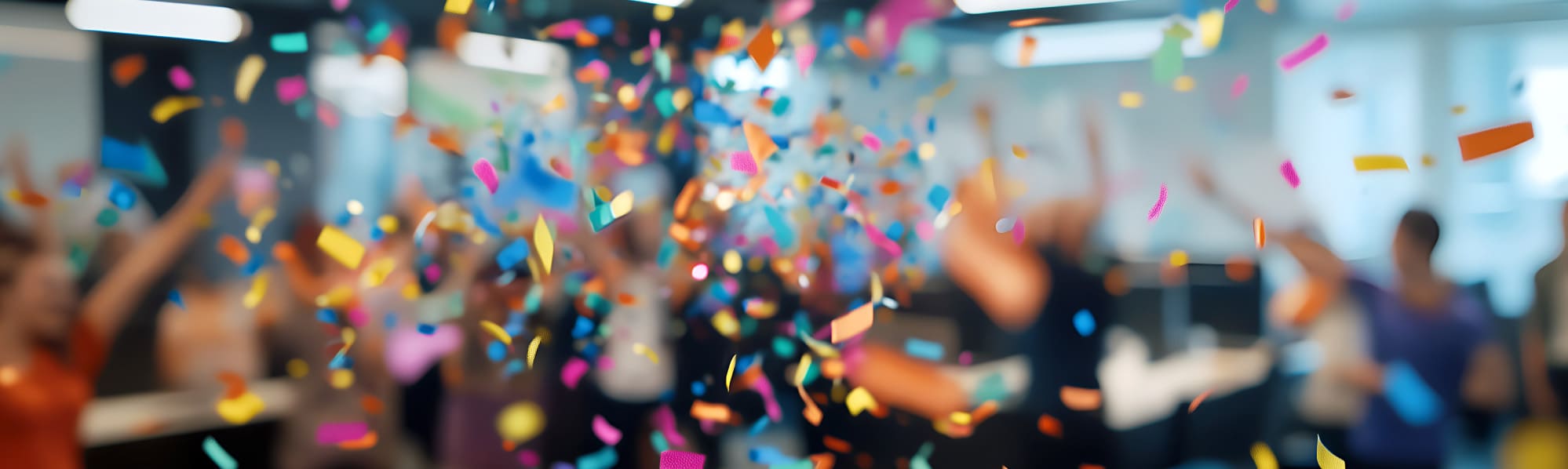 Colourful confetti falling in a room - blurred background.